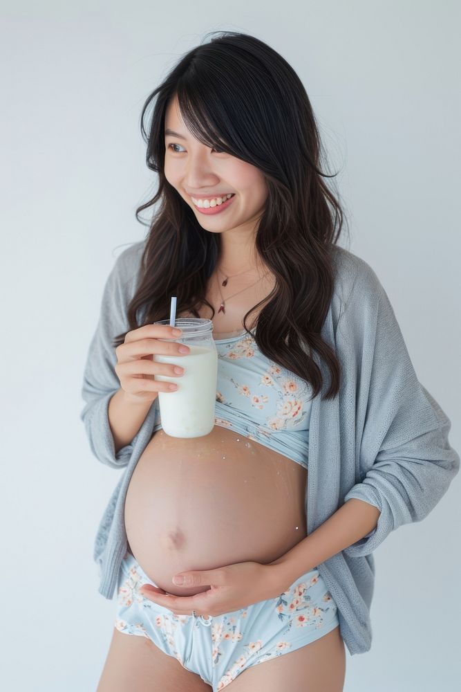 Pregnant asian woman portrait milk drinking.