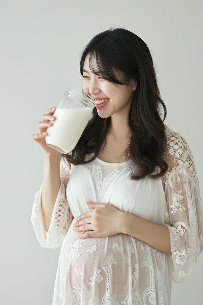 Pregnant asian woman milk drinking portrait.