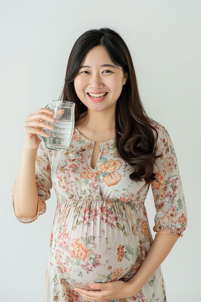 Pregnant asian woman portrait drinking smiling.