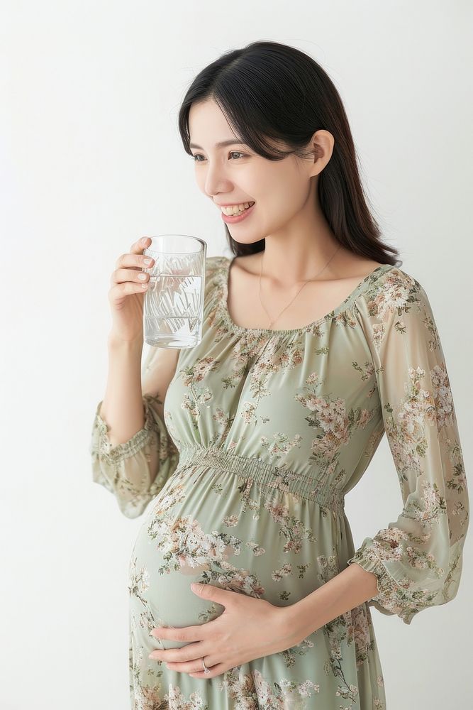 Pregnant asian woman portrait drinking smiling.