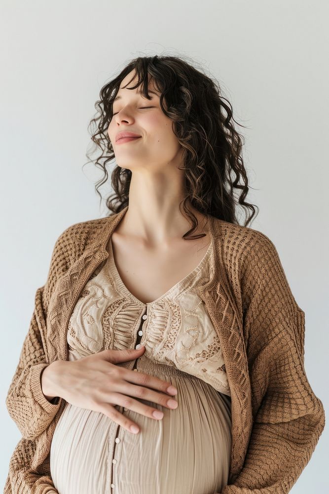 Pregnant latin woman portrait sweater smiling.
