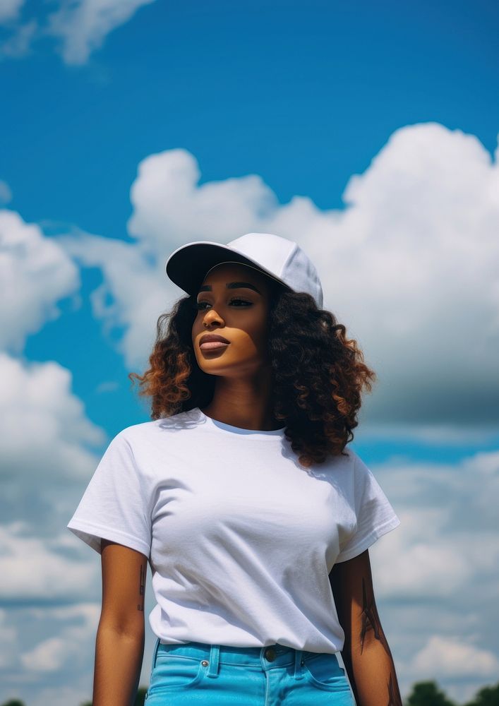 Black young woman wearing a white tank top and back cap standing blue sky. AI generated Image by rawpixel.
