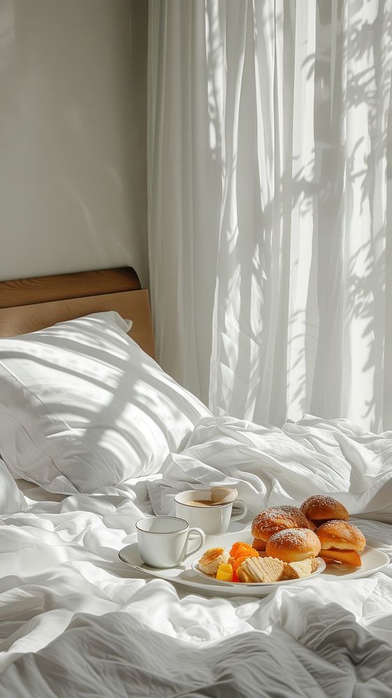 Breakfast tray on hotel bed furniture pillow food.