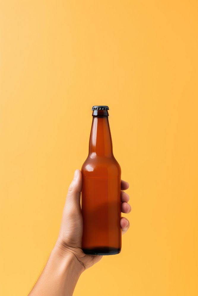 Hand holding beer bottle drink refreshment container.