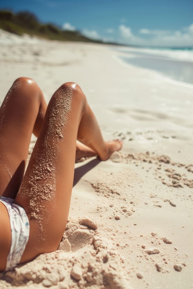 Woman legs on beach sand sunbathing outdoors nature.