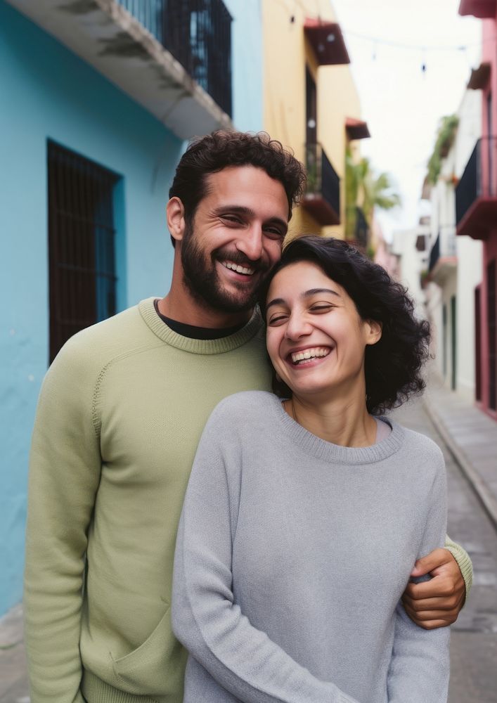 Hispanic cute couple street laughing portrait.