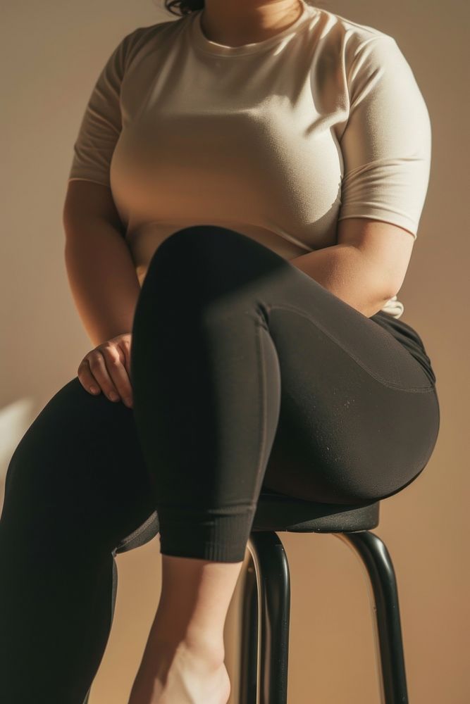 Chubby woman waist wearing exercise pants sitting adult exercising.