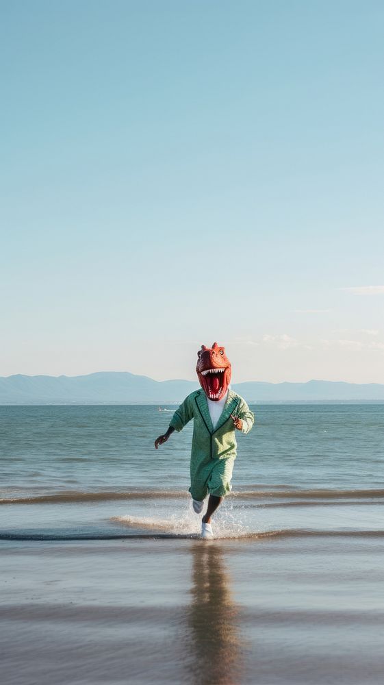  Man in dinosaur cosplay running over the sea photography outdoors horizon. AI generated Image by rawpixel.