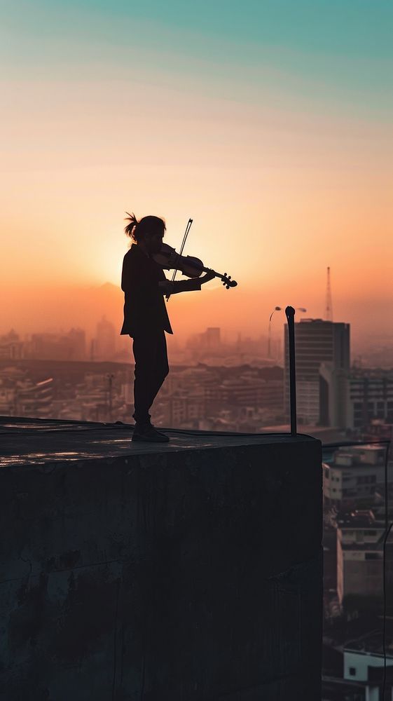  Musician playing violin at the rooftop architecture cityscape building. AI generated Image by rawpixel.