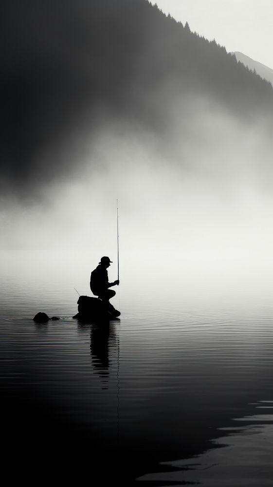 Man fishing near lake silhouette monochrome outdoors.