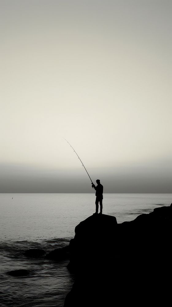 Man fishing at ocean monochrome outdoors nature.