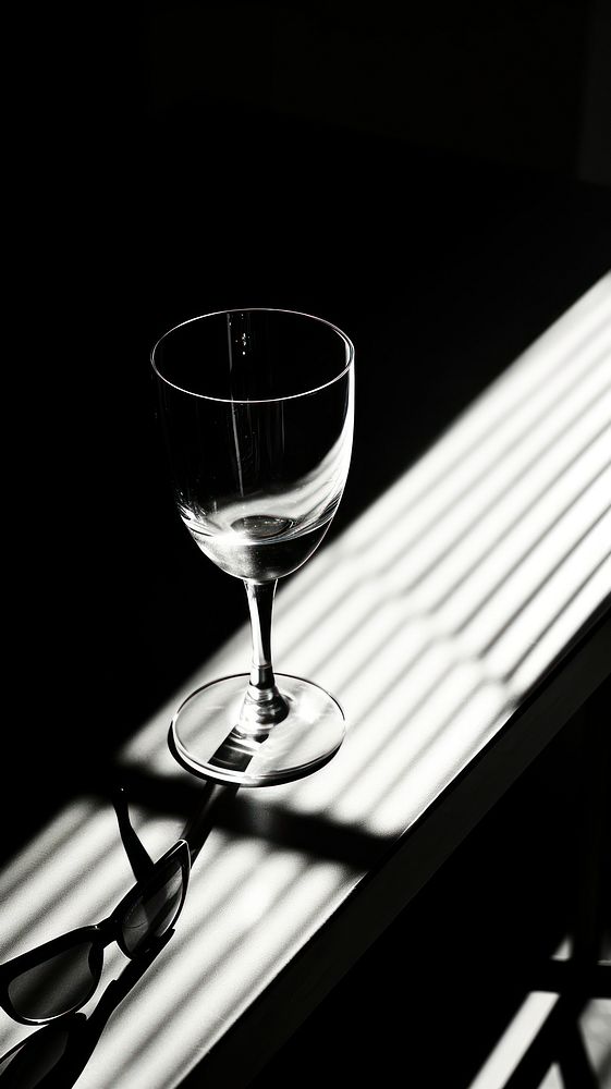 Glasses on table reflect sunlight monochrome drink black.