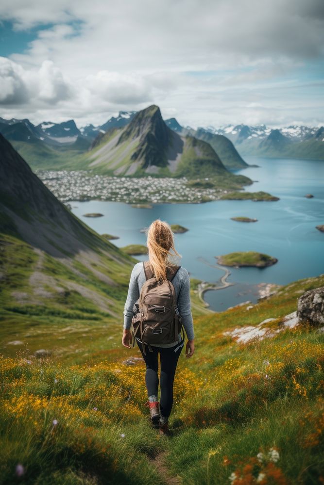 Woman hiking at Lofoten Norway adventure outdoors backpack.