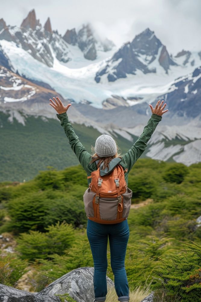 Woman in back raising arms at patagonia hiking adult happy.
