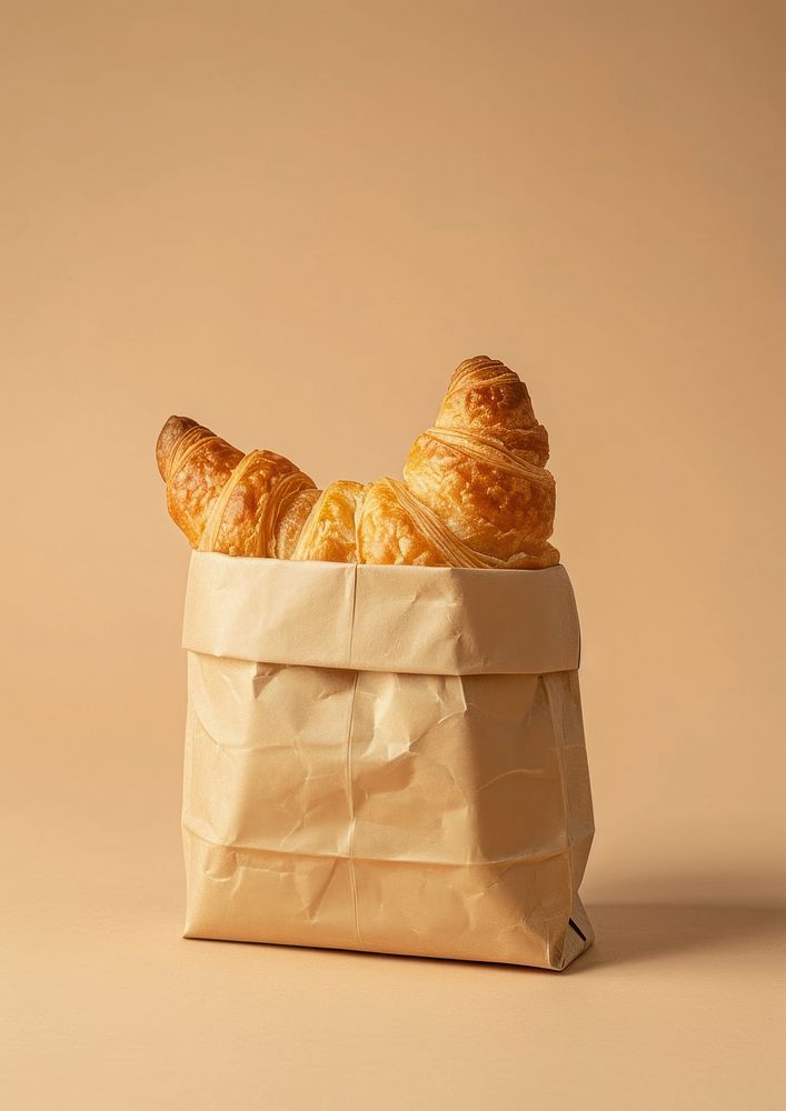Croissant in th snack paper bag  bread food viennoiserie.