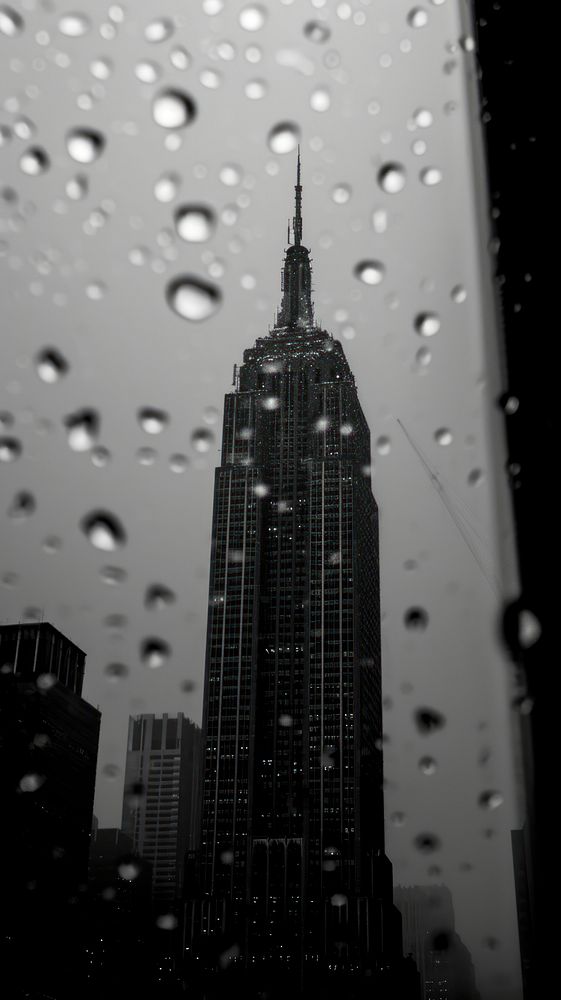 Photography of raining empire state building architecture motion tower.