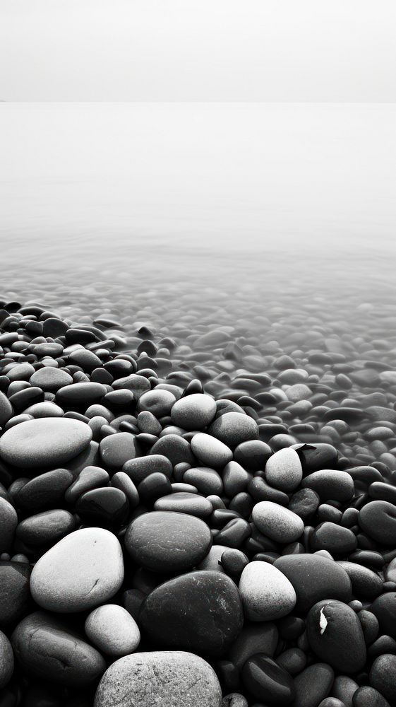 Photography of ocean with beach and stones monochrome pebble tranquility.