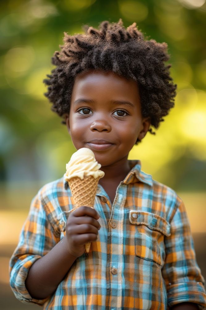 A little boy holding an ice cream cone dessert child food.
