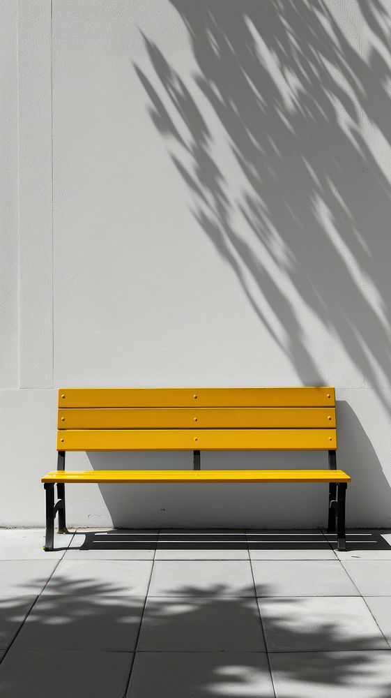 A yellow bench furniture shadow wall.