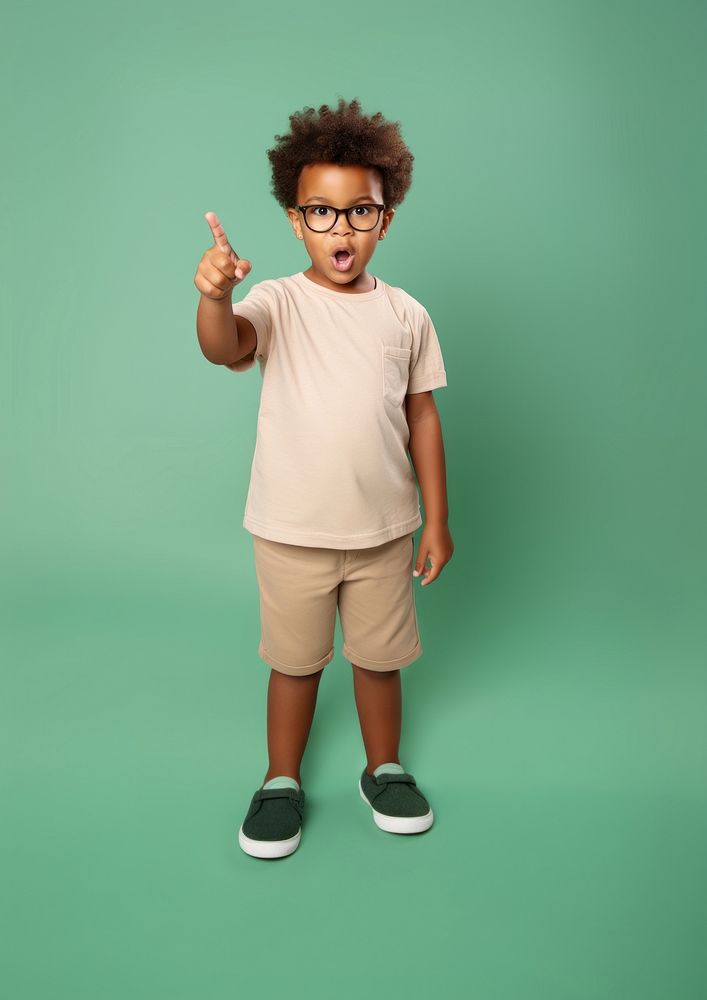 Kid pointing finger at mouth portrait glasses t-shirt. AI generated Image by rawpixel.