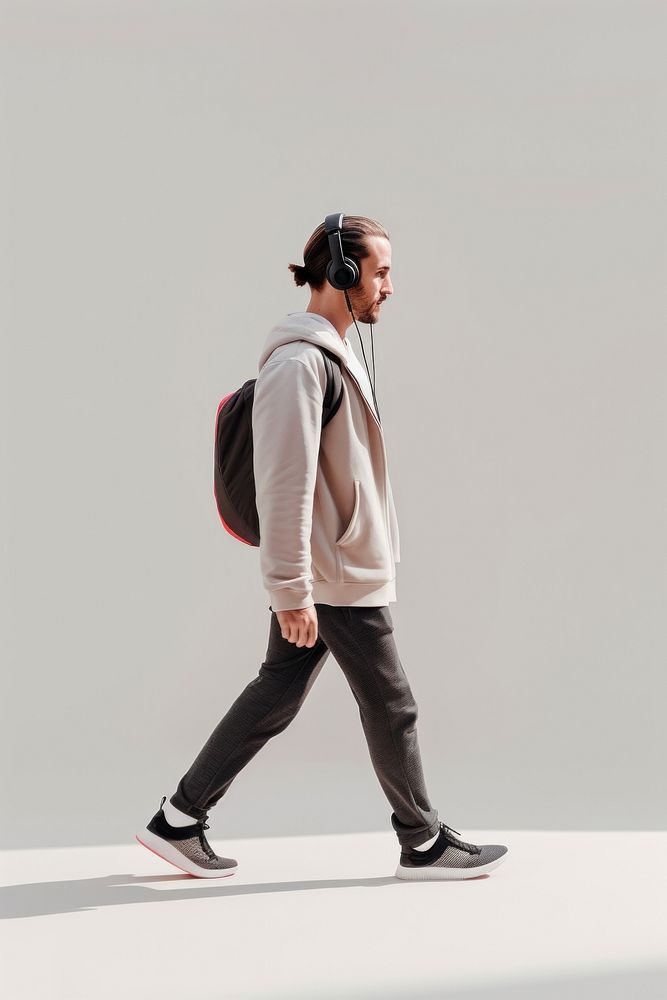 A man with headphone walking headphones footwear.