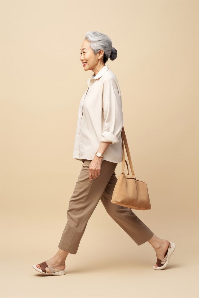 A Asian senior woman walking footwear handbag.