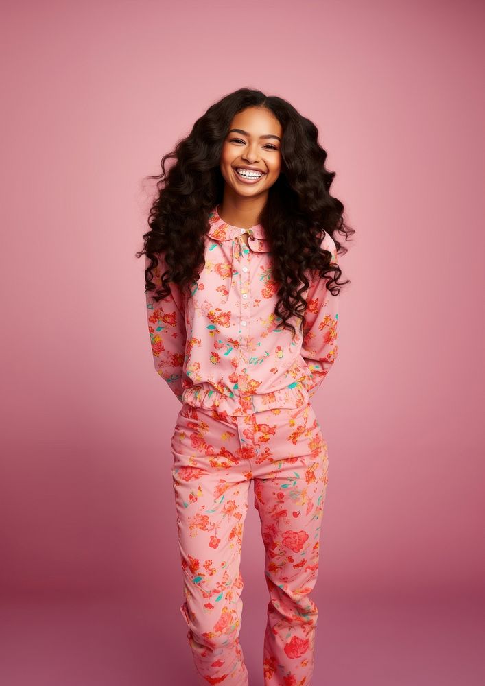 Young African American woman stands smile pink long hair.
