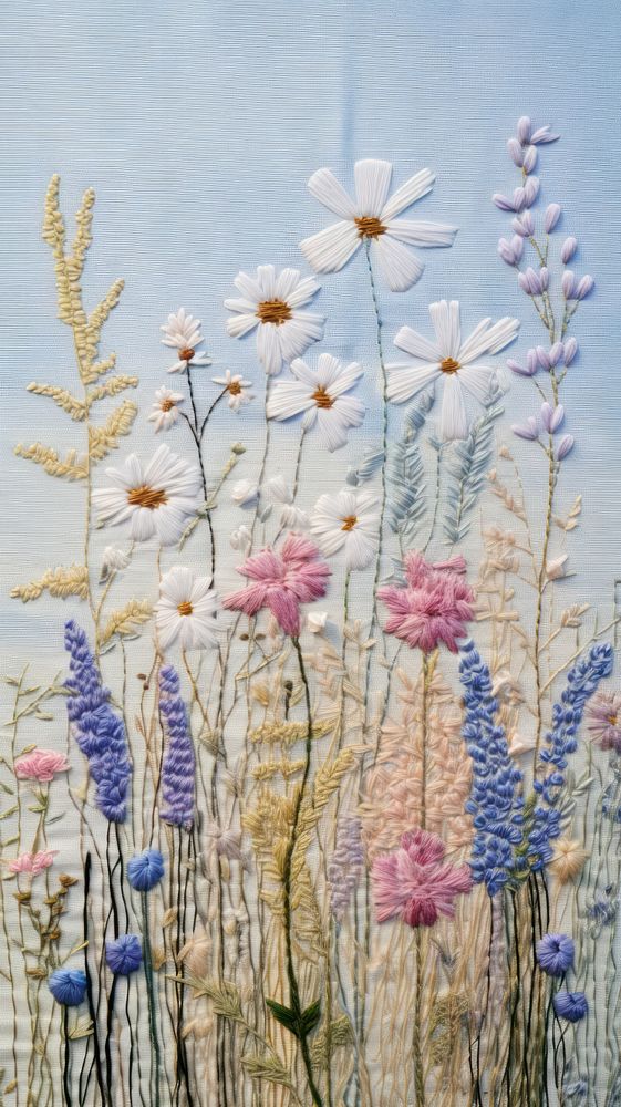 Embroidery with meadow flowers needlework painting outdoors.