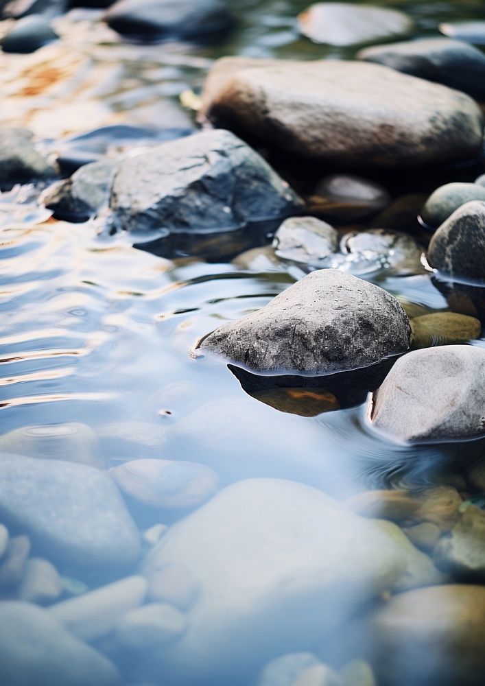  A minimal stream of water and rocks outdoors nature pebble. AI generated Image by rawpixel.