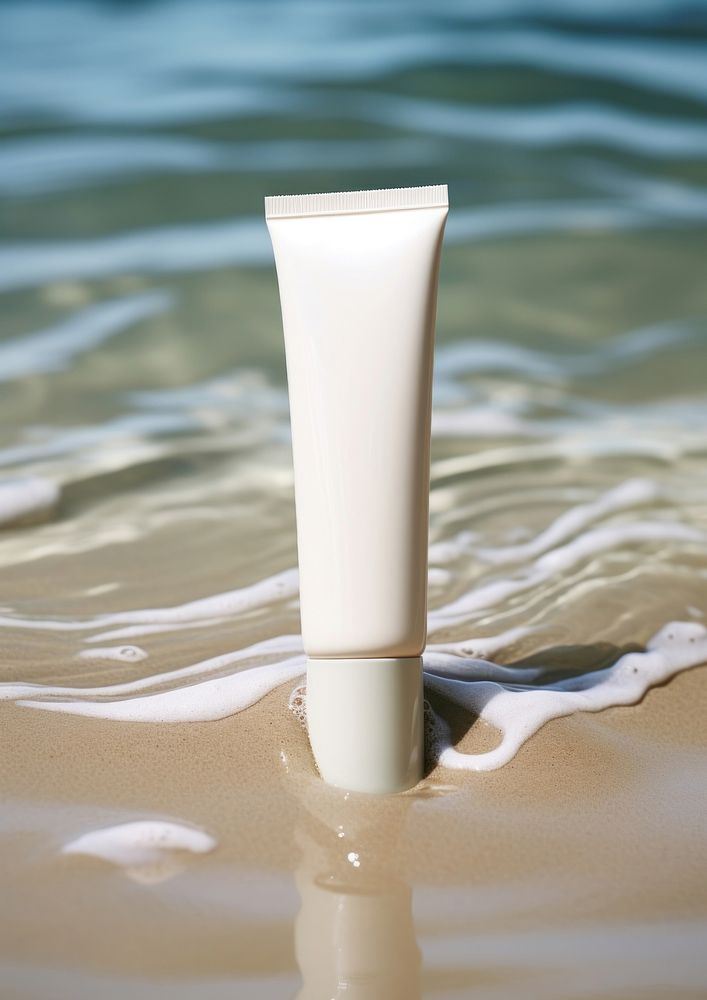  A tube of cream sitting in a stream of water sea reflection cosmetics. 