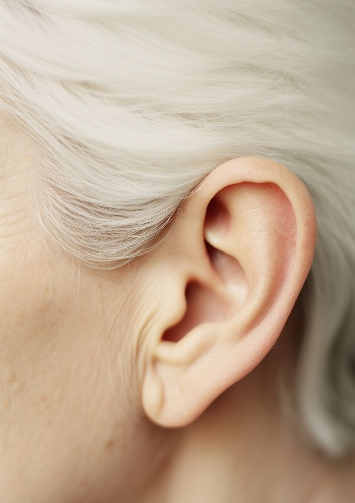 A elderly woman ear jewelry earring white.