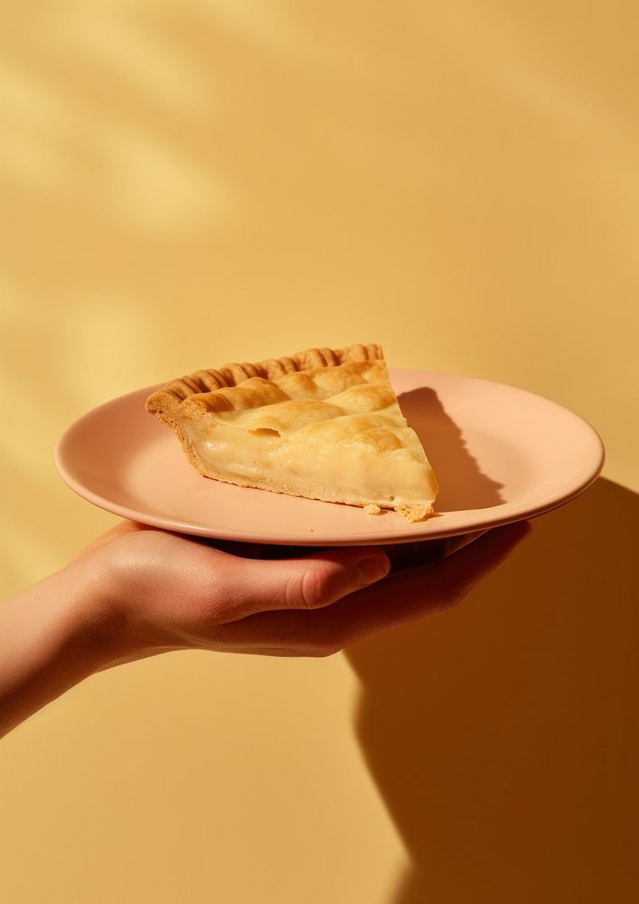 A person holding piece of pie on plate dessert food freshness.