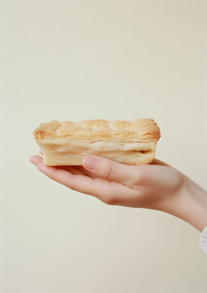 A person holding piece of apple pie dessert pastry food.