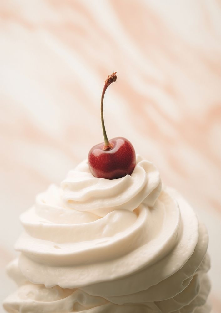 A whipped cream and a cherry on top dessert plant food.