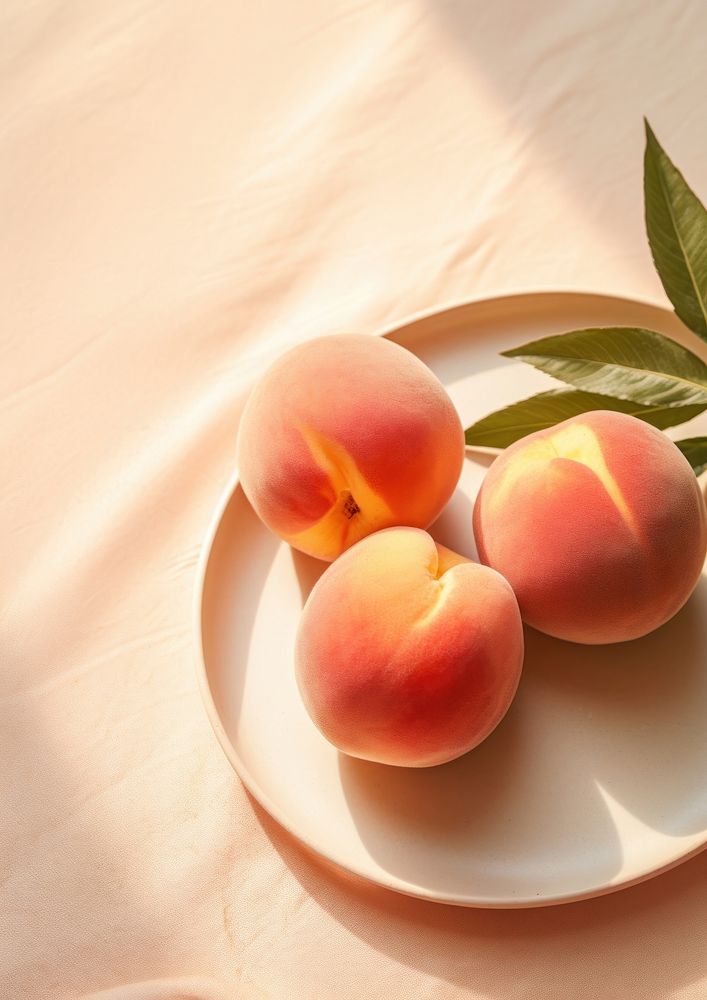 Three peaches on a plate fruit plant food.