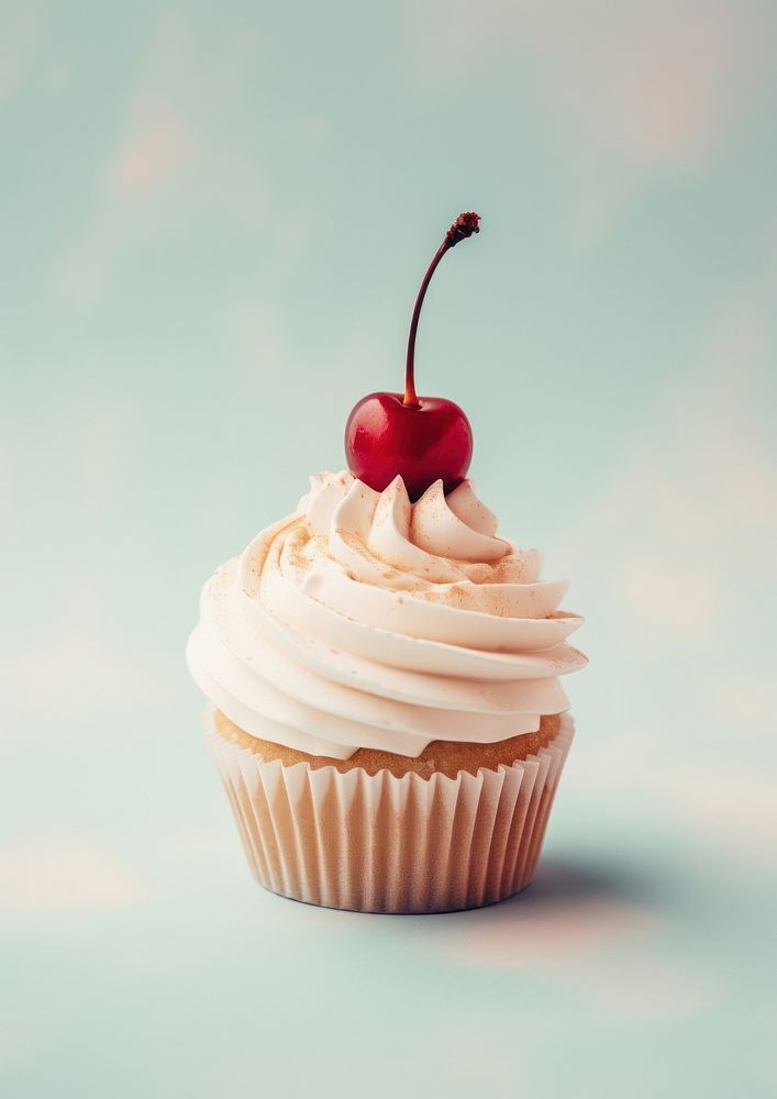 A cupcake with whipped cream and a cherry on top with mirror dessert fruit food.