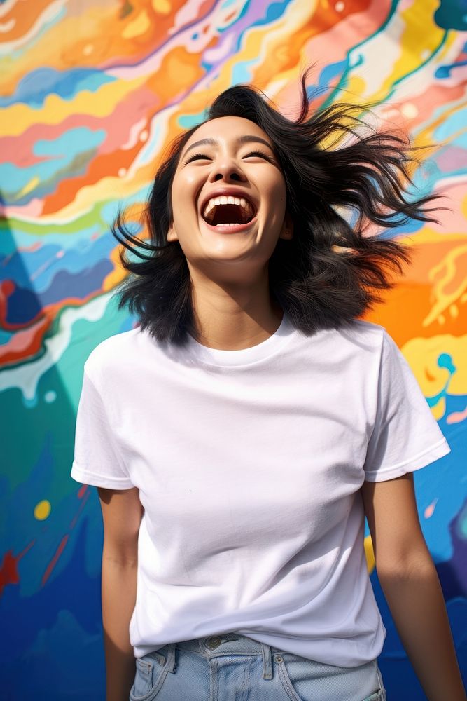 Asian American woman wearing white t-shirt laughing adult fun.