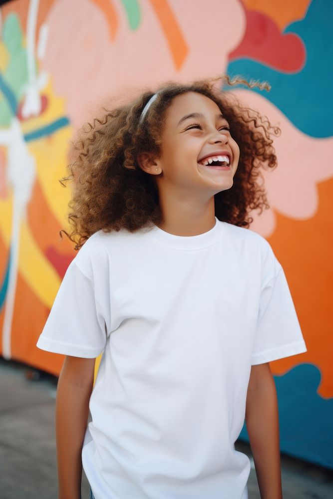 A female kid wearing white t-shirt laughing smile fun.