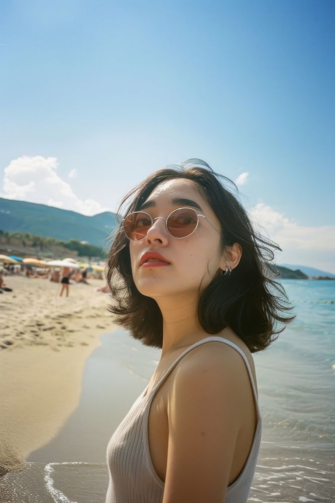 Japanese woman selfie beach sunglasses portrait.