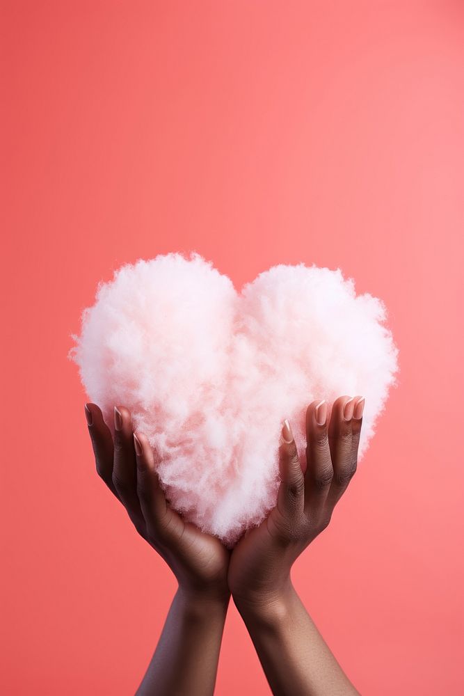 Hand holding a white fluffy heart pink red symbol. AI generated Image by rawpixel.