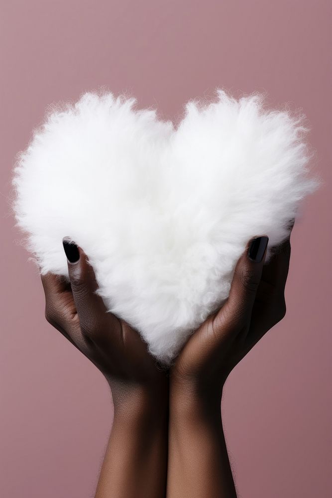 Hand holding a white fluffy heart adult softness female. AI generated Image by rawpixel.