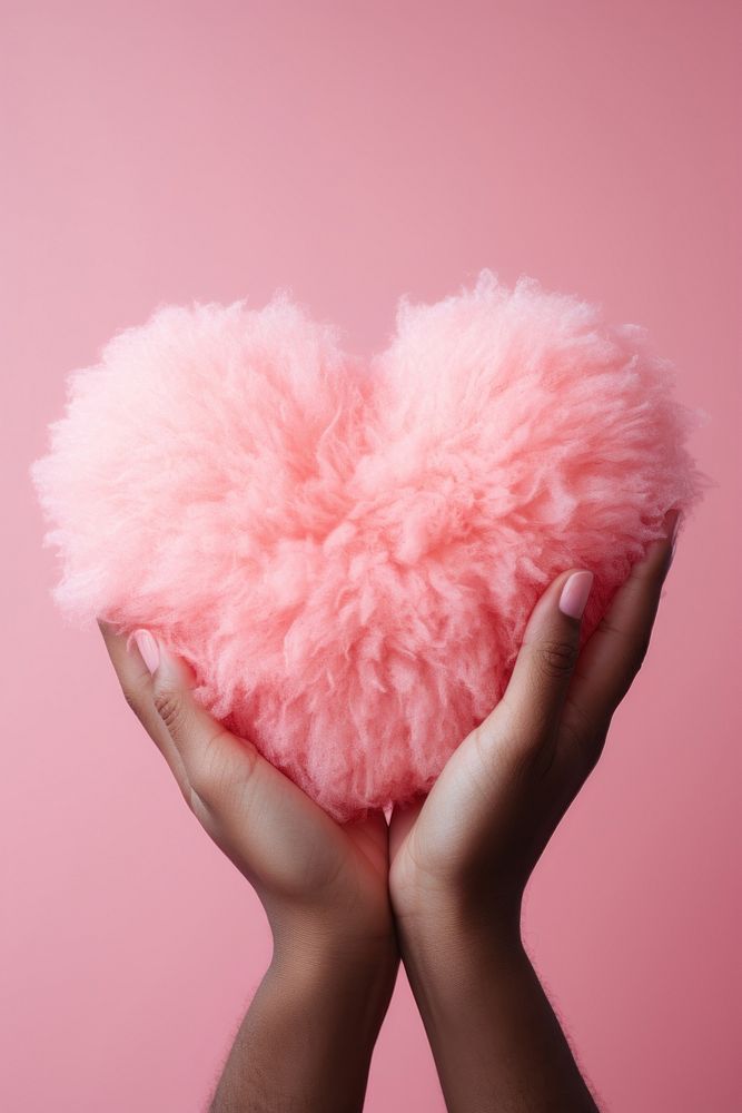 Hand holding fluffy heart pink red celebration. AI generated Image by rawpixel.