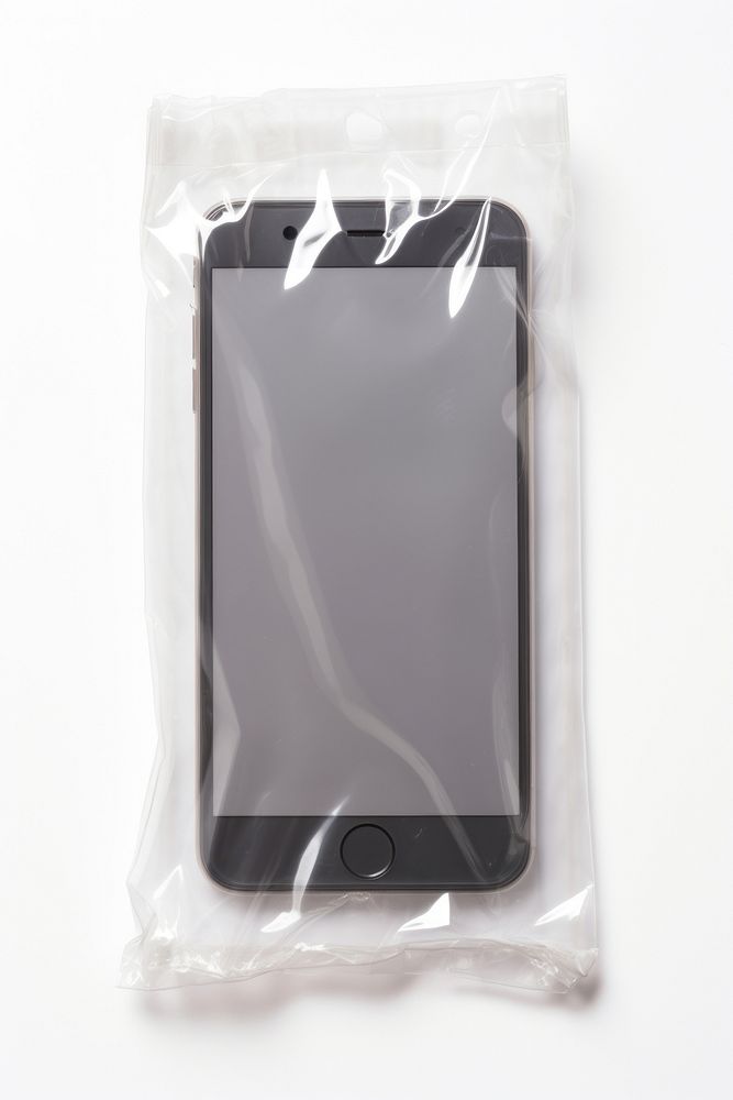 Plastic wrapping over a mobilephone white background electronics technology.