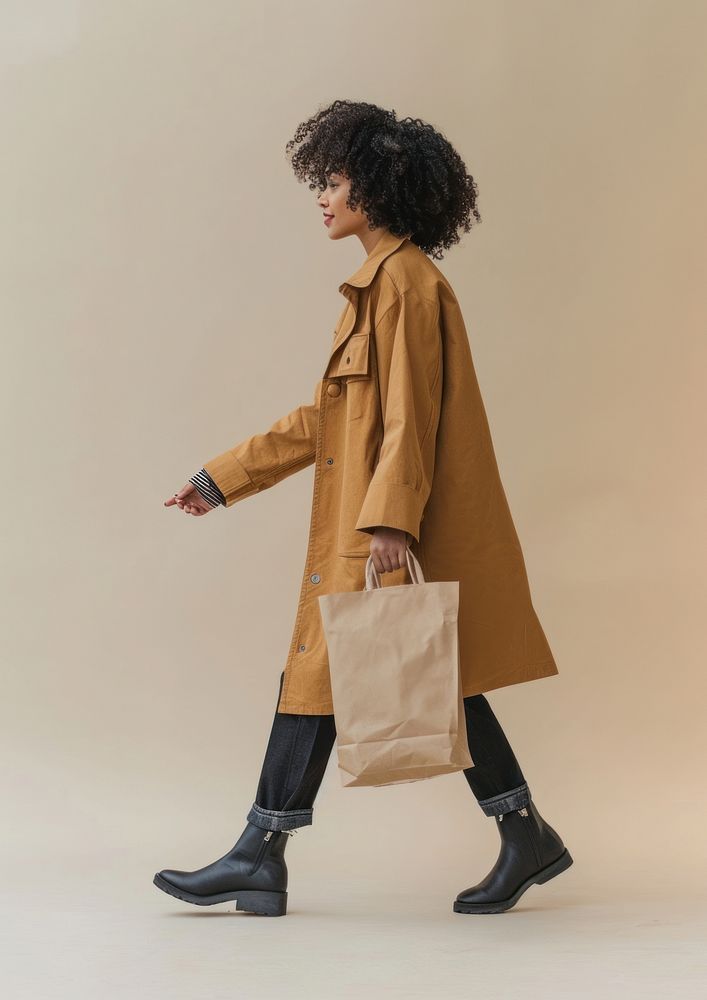 Photo of woman wearing casual outfit bag walking coat.