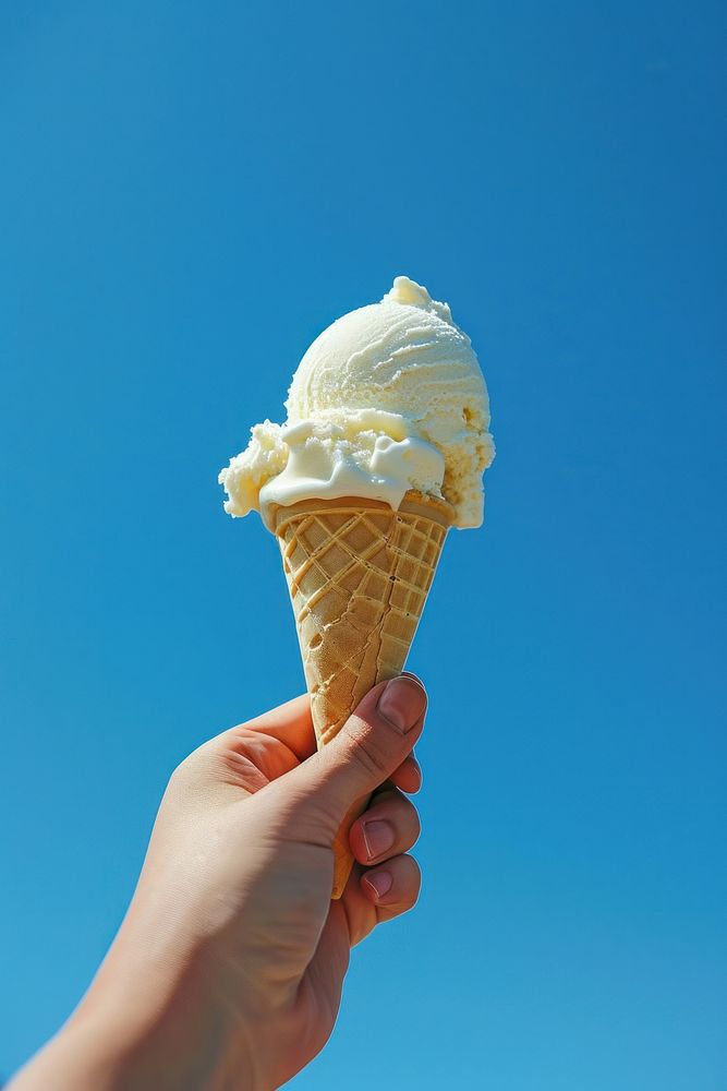 Photo of hand holding ice cream dessert food blue.