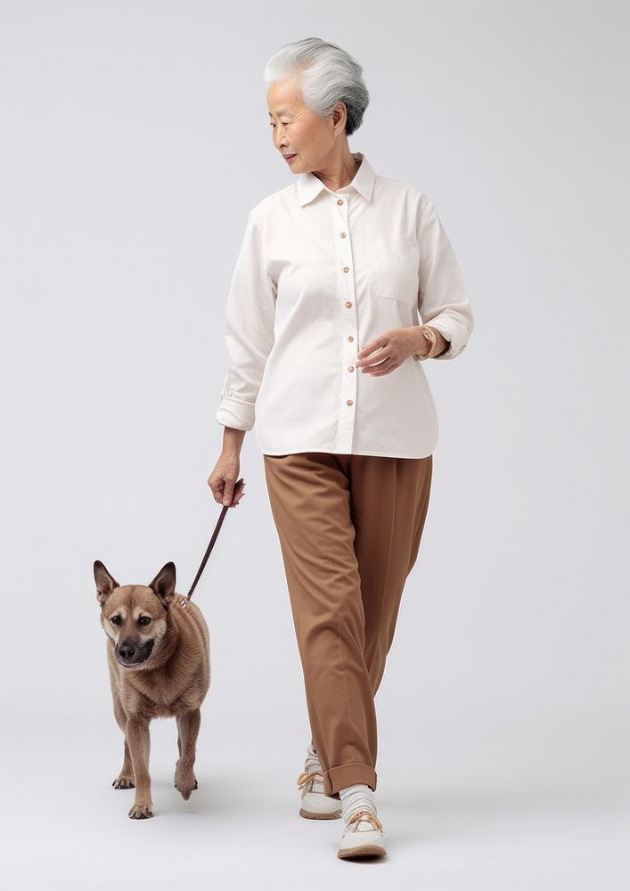 Cream shirt and pant  walking dog mammal.