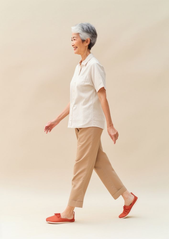 Cream shirt and pant  walking footwear person.