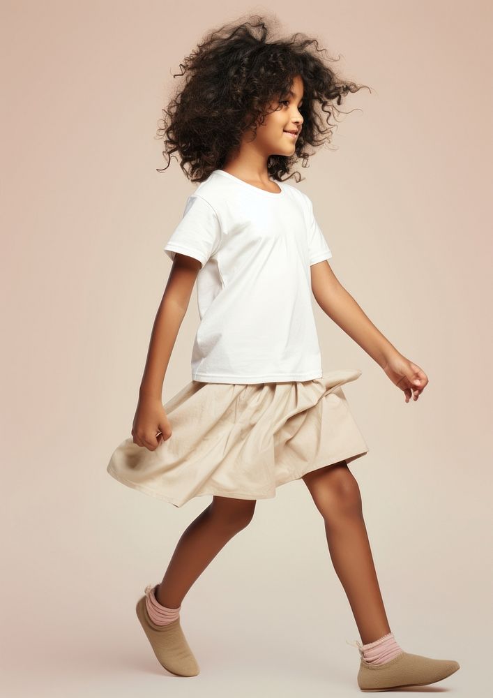 Cream t-shirt and skirt  footwear person child.