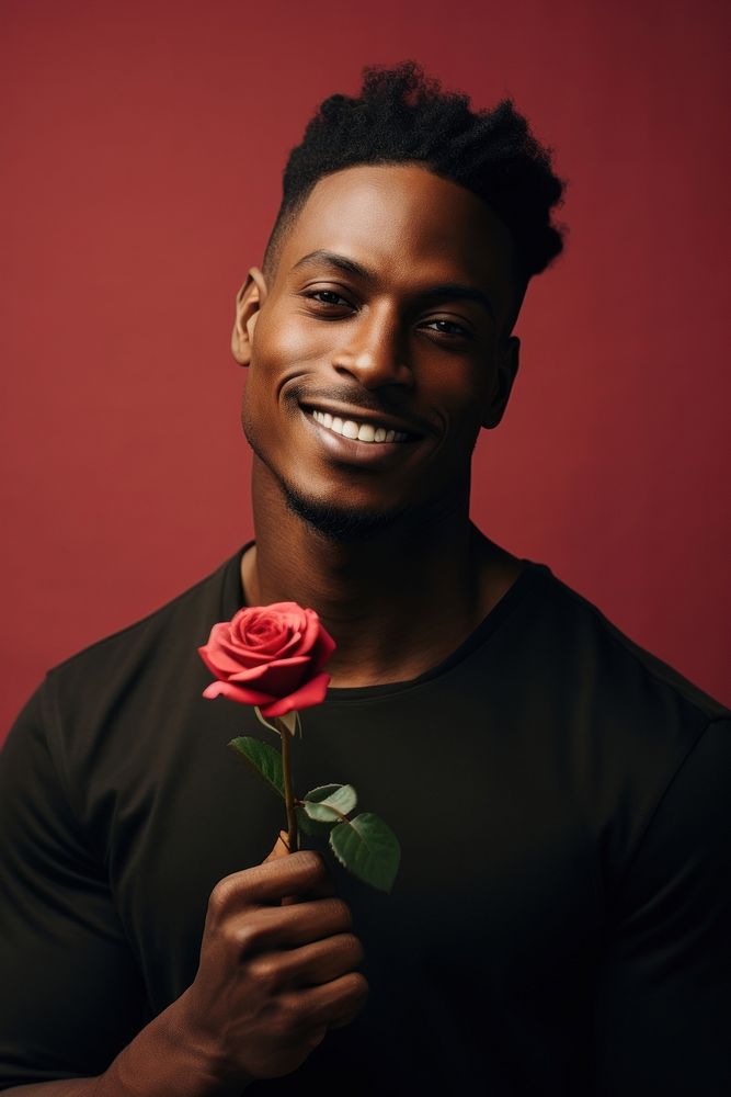 Black man holding red rose portrait smiling flower.