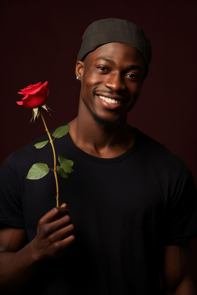 Black man holding red rose portrait smiling flower.